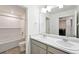 Well-lit bathroom with double sinks, white subway tile, and modern fixtures at 226 Racer St, Bennett, CO 80102