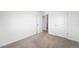Bright bedroom with neutral carpet, white walls, closet, and natural light at 226 Racer St, Bennett, CO 80102