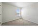 Clean, carpeted bedroom with a large window, neutral paint, and ample natural light in this versatile living space at 226 Racer St, Bennett, CO 80102