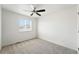 Bright bedroom features neutral carpet, ceiling fan, and a window at 226 Racer St, Bennett, CO 80102