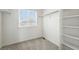 Walk-in closet with built-in shelving, natural light from a window, and plenty of storage space at 226 Racer St, Bennett, CO 80102