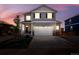 Charming two-story home with a neutral gray exterior, neat landscaping, and attached two-car garage at 226 Racer St, Bennett, CO 80102