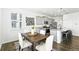 A stylish dining area and kitchen with gray cabinets, granite counters, stainless appliances, and a cozy breakfast bar at 226 Racer St, Bennett, CO 80102