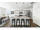 Open kitchen boasts a large island, stainless appliances, and seamless flow to the adjacent dining area at 226 Racer St, Bennett, CO 80102