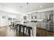 This modern kitchen features an island with barstool seating and stainless steel appliances at 226 Racer St, Bennett, CO 80102