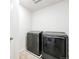 Modern laundry room featuring new front load washer and dryer units at 226 Racer St, Bennett, CO 80102