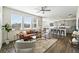 Inviting living space showcasing seamless integration with a modern kitchen and hardwood-style floors at 226 Racer St, Bennett, CO 80102