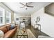 This open-concept living room features a ceiling fan and seamlessly connects to the modern kitchen at 226 Racer St, Bennett, CO 80102