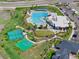 Aerial view showcasing the pool, sports courts, and clubhouse at 12826 Lake Port St, Longmont, CO 80504