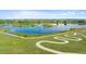 Scenic aerial view of a community lake with a winding walking path at 12826 Lake Port St, Longmont, CO 80504