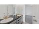 Bathroom featuring a double sink vanity and a door leading to the bedroom at 12826 Lake Port St, Longmont, CO 80504
