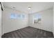 Well-lit bedroom featuring three windows, grey carpet, and a closet, creating a bright and welcoming space at 12826 Lake Port St, Longmont, CO 80504