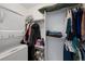 Walk-in closet with neatly organized storage and a stacked washer and dryer at 12826 Lake Port St, Longmont, CO 80504