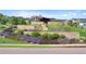 Landscaped entrance to Barefoot Lakes community featuring stone accents and lush greenery at 12826 Lake Port St, Longmont, CO 80504