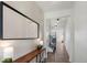 Bright foyer with hard wood floors, console table with lamps, and stairway to the second floor at 12826 Lake Port St, Longmont, CO 80504