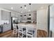 Modern kitchen with stainless steel appliances, an island with seating, and ample cabinet space at 12826 Lake Port St, Longmont, CO 80504