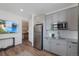 Modern kitchen with stainless steel appliances, gray cabinetry, and granite countertops at 12826 Lake Port St, Longmont, CO 80504