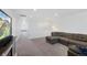 Spacious living room with neutral carpet, sectional couch, and large TV at 12826 Lake Port St, Longmont, CO 80504