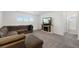 Cozy living room with a sectional sofa, fireplace, and large windows at 12826 Lake Port St, Longmont, CO 80504