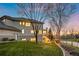 Backyard with large grass area with mature trees surrounding back of house at 4505 W 100Th Ave, Westminster, CO 80031