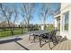 Outdoor deck with wrought iron furniture overlooking lush green golf course on a bright day at 4505 W 100Th Ave, Westminster, CO 80031