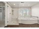 Bright bathroom with a separate shower, soaking tub, and tiled floor at 4505 W 100Th Ave, Westminster, CO 80031