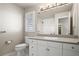 Bathroom featuring white vanity, toilet, shower and bath, a large mirror, and plantation shutters at 4505 W 100Th Ave, Westminster, CO 80031