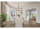 Sunlit dining area featuring a round table, white chairs, and views of the outdoors through shuttered windows at 4505 W 100Th Ave, Westminster, CO 80031