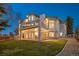 Multi-level home with balconies, stone accents, manicured lawn, and outdoor string lights at 4505 W 100Th Ave, Westminster, CO 80031