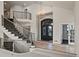 Grand foyer with curved staircase, high ceilings, chandelier, and a view of the front door at 4505 W 100Th Ave, Westminster, CO 80031