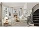 Comfortable living room features a stone fireplace, large windows, and staircase at 4505 W 100Th Ave, Westminster, CO 80031