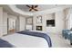 Bright main bedroom featuring a fireplace, TV, and a tray ceiling with ceiling fan at 4505 W 100Th Ave, Westminster, CO 80031