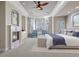 Bright main bedroom with fireplace, bay window seating, and a tray ceiling with ceiling fan at 4505 W 100Th Ave, Westminster, CO 80031
