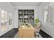 Well-appointed home office featuring a custom bookcase, a large window with shutters, and French doors at 4505 W 100Th Ave, Westminster, CO 80031