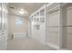 Spacious walk-in closet with custom shelving and a bench at 4505 W 100Th Ave, Westminster, CO 80031