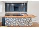 Wet bar in basement features granite countertops, stone surround, and navy cabinets at 4505 W 100Th Ave, Westminster, CO 80031
