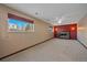 Spacious basement recreation room with fireplace and carpet flooring at 9563 W Capri Ave, Littleton, CO 80123