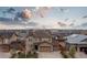 An aerial view of a neighborhood showcasing a brown home with an attached three-car garage at 25064 E Archer Pl, Aurora, CO 80018