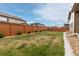 Spacious backyard with a well-maintained lawn, fence, and garden area at 25064 E Archer Pl, Aurora, CO 80018
