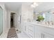 Bathroom featuring double vanity, white cabinets, and modern fixtures at 25064 E Archer Pl, Aurora, CO 80018