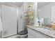 Bathroom featuring a glass shower, granite countertop vanity, and storage shelving at 25064 E Archer Pl, Aurora, CO 80018
