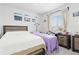 Bedroom with two beds, a nightstand, decorative pictures and a sun-filled window at 25064 E Archer Pl, Aurora, CO 80018