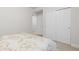 Simple bedroom featuring a bed and access to closets and other rooms at 25064 E Archer Pl, Aurora, CO 80018