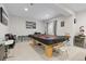 Large game room with a billiards table, bar stools, and a refreshment center at 25064 E Archer Pl, Aurora, CO 80018
