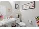 A clean half-bath features a white vanity with a round mirror and decor at 25064 E Archer Pl, Aurora, CO 80018