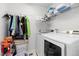 Well-organized laundry room featuring a washer, dryer, storage, and folding area at 25064 E Archer Pl, Aurora, CO 80018