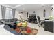 Cozy living room with a comfortable leather sofa, decorative rug, and a modern entertainment center at 25064 E Archer Pl, Aurora, CO 80018