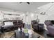 An open-concept living room boasts a dark wooden floor, a large sofa, and a staircase at 25064 E Archer Pl, Aurora, CO 80018