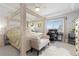 Large bedroom with a four-poster bed, office space and beverage center at 25064 E Archer Pl, Aurora, CO 80018