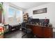 Office with bright natural light, dark wood floors, and built-in shelving at 25064 E Archer Pl, Aurora, CO 80018